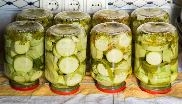 canned vegetable marrow in glass jars during home canning - zucchini squash marrow squash vegetable imagens e fotografias de stock