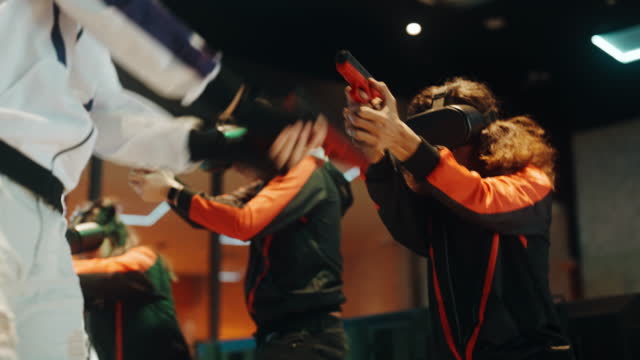2 Asian Esports teams playing VR shooting videogame competing each other in grand final on stage
