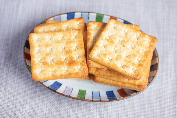 istock A pile of dry, thin crackers in a cup. Natural light. 1412810984