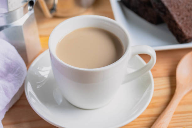 istock Hot coffee latte in a white coffee mug with cake.Breakfast 1412811102