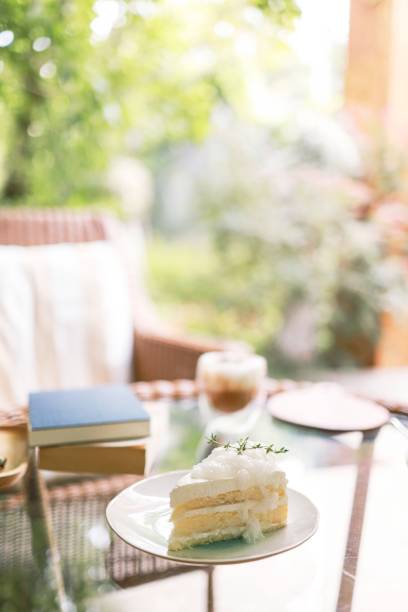 Coconut Cake and Coffee in a cafe on the blur background. traditional dessert Sliced of delicious coconut layer cake