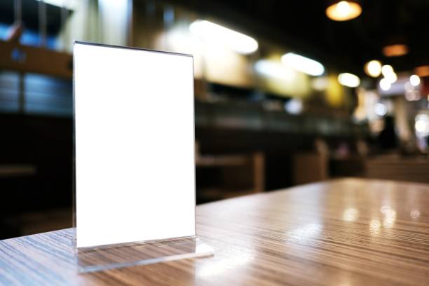 istock Mock up Menu frame standing on wood table in Bar restaurant cafe. space for text 1412813592