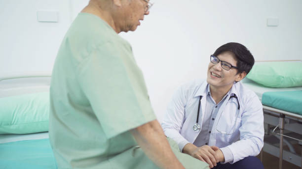 istock Happy old elderly Asian patient or pensioner and a doctor smiling, doing exercise, working out  in nursing home in hospital. Senior people lifestyle activity recreation. Health care physical therapy. 1412814593