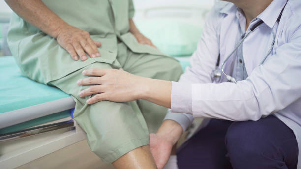 istock Happy old elderly Asian patient or pensioner and a doctor smiling, doing exercise, working out  in nursing home in hospital. Senior people lifestyle activity recreation. Health care physical therapy. 1412814610