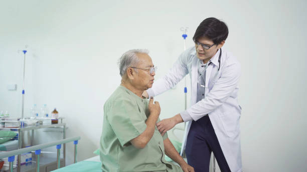 istock Happy old elderly Asian patient or pensioner and a doctor smiling, doing exercise, working out  in nursing home in hospital. Senior people lifestyle activity recreation. Health care physical therapy. 1412814627
