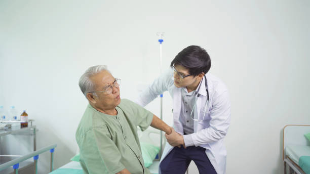istock Happy old elderly Asian patient or pensioner and a doctor smiling, doing exercise, working out  in nursing home in hospital. Senior people lifestyle activity recreation. Health care physical therapy. 1412814661