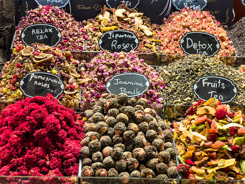 Various Turkish floral dried fruit tea with name tags for sale at the Grand Bazaar in Istanbul, Turkey. Multicolored food and drink background with copy space.