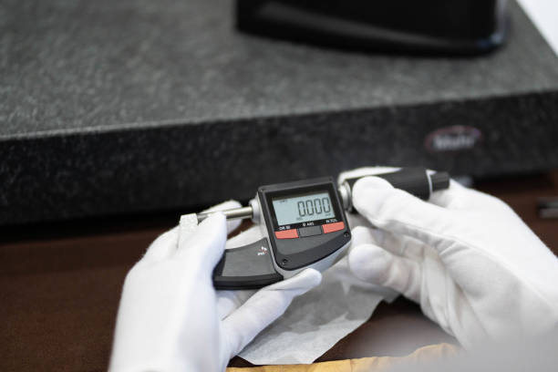 istock Industrial worker measure detail with digital caliper micrometer at factory workshop 1412817109