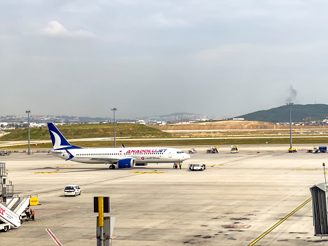 Istanbul - Turkey, 06/23/2022: Real outdoor scene at International Sabiha Gokcen Airport. AnadoluJet is a brand of Turkish Airlines operating as a regional airline. It operates domestic flights for its parent company. Air travel background with copy space.