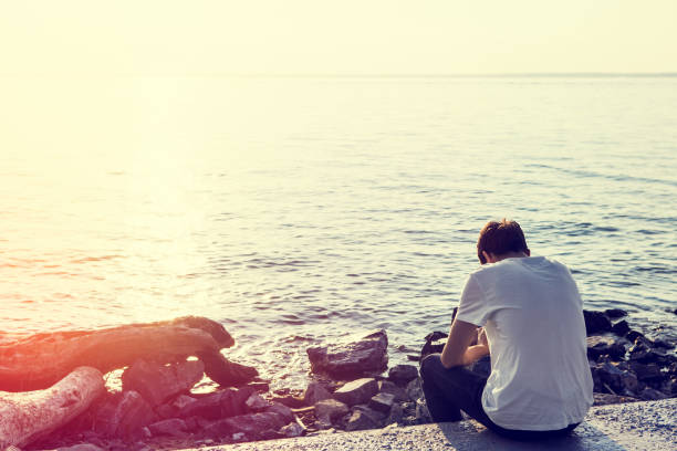 istock Lonely Young Man outdoor 1412817864