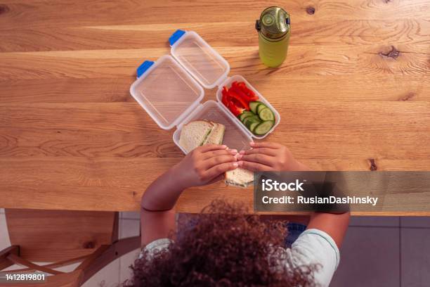 Top View Image Of A Little Student Girl Eating Healthy Lunch At School Stock Photo - Download Image Now