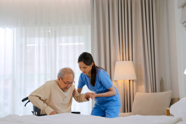 Nurse take care senior man in the bedroom. stock photo