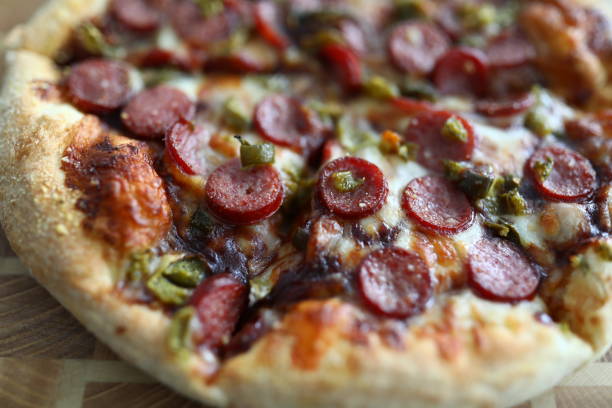 Fresh baked pizza with crusty cheese and hot tasty pepperoni ready to eat