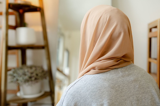Asian muslim woman wearing a hijab before going out in the morning.