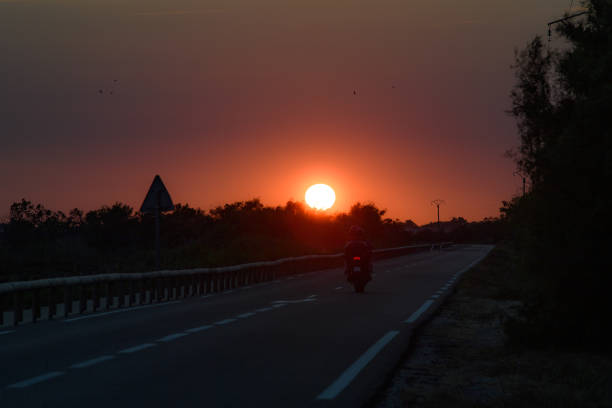 Motorbike on a road at sunset