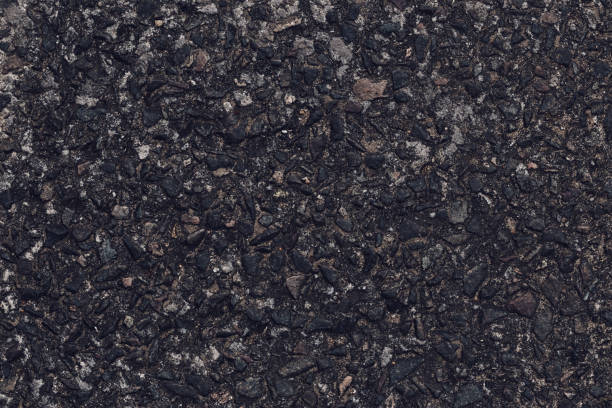 istock Asphalt texture, natural black pattern of roadway for design, grainy surface of pavement. Abstract dark wallpaper. Old weathered urban wall. Template with blank space. 1412829024