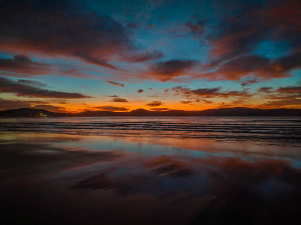 istock Winter sunrise at the seaside with high cloud and reflections 1412829028