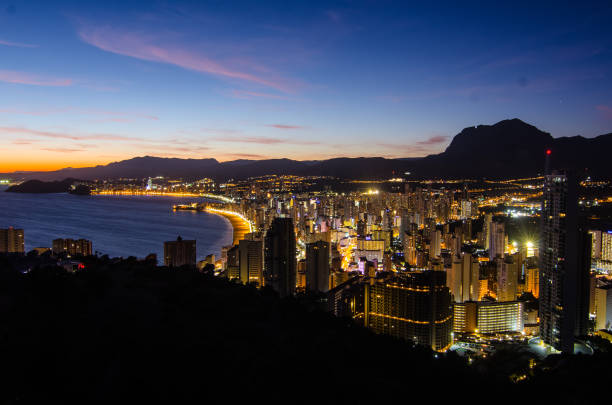 Benidorm, Costa Blanca, Spain at sunset in summer time with a few clouds stock photo