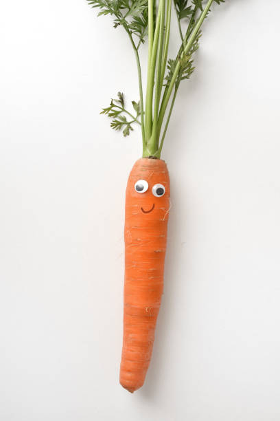 istock Healthy fresh carrot with face on white isolated background 1412834944