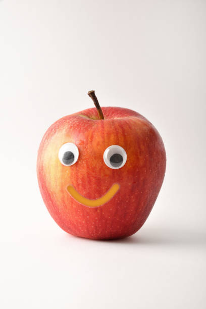 istock Healthy red apple with face on white isolated background 1412834980