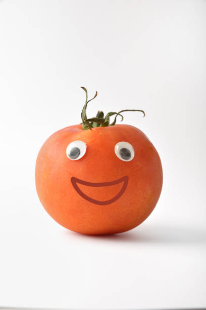 istock Healthy fresh tomato with face on white isolated background 1412835001