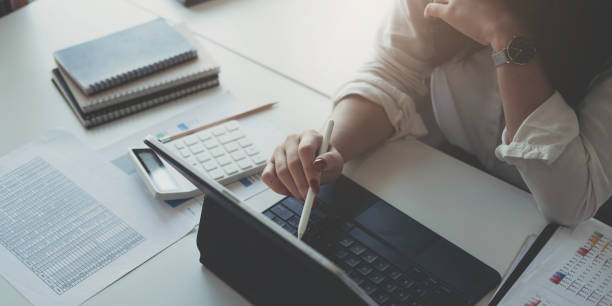 istock Businesswoman using laptop computer keyboard at the office. 1412835019
