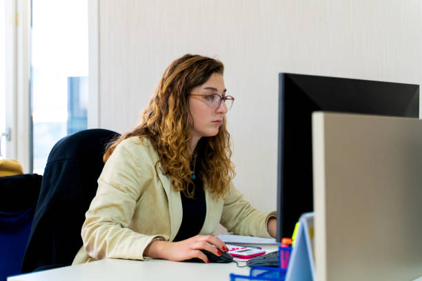 istock Portrait of a woman using his computer in a modern office 1412835033