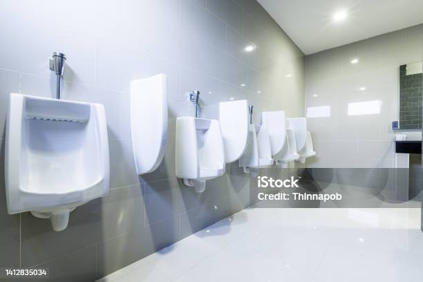 Contemporary Public Interior Of Bathroom With Toilet Urinals Lined Up Modern Design No Privacy Stock Photo - Download Image Now