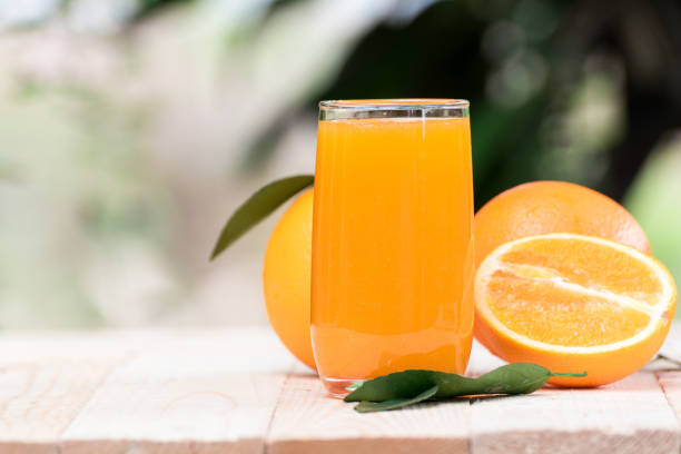 istock fresh orange juice with orange fruit outdoor table 1412835401