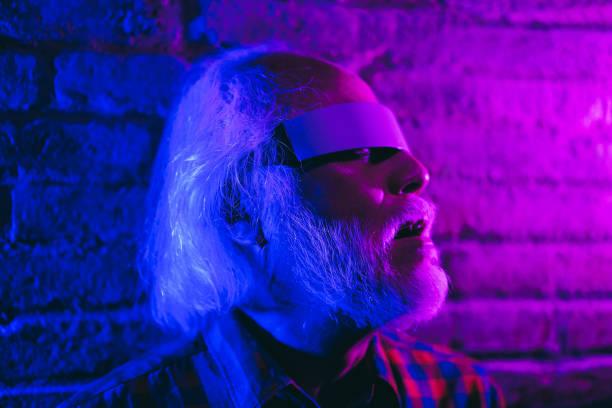 istock Asian senior man using augmented reality futuristic glasses - New metaverse technology trend concept 1412836640