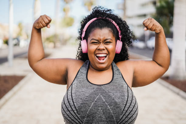 istock Happy curvy african woman doing workout routine outdoor 1412836856