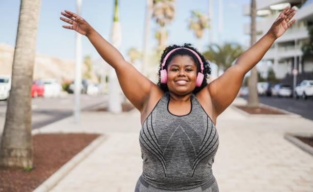 istock Happy curvy african woman doing workout routine outdoor 1412836857