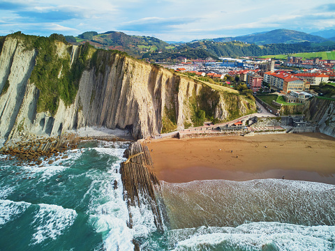 Aerial drone view of famous flysch of Zumaia, Basque Country, Spain. Flysch is a sequence of sedimentary rock layers that progress from deep-water