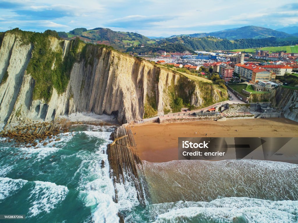 Famous flysch of Zumaia, Basque Country, Spain Aerial drone view of famous flysch of Zumaia, Basque Country, Spain. Flysch is a sequence of sedimentary rock layers that progress from deep-water Bay Of Biscay Stock Photo