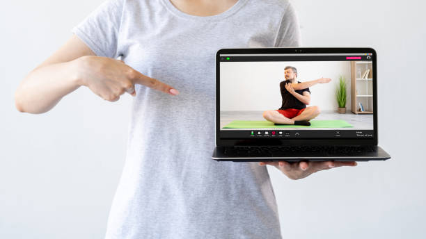 istock fitness online virtual gym laptop man exercise 1412842782