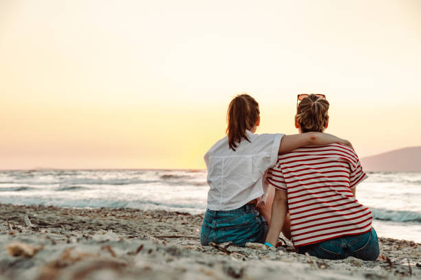 istock Relaxing on the beach in sunset and looking at the view 1412842884