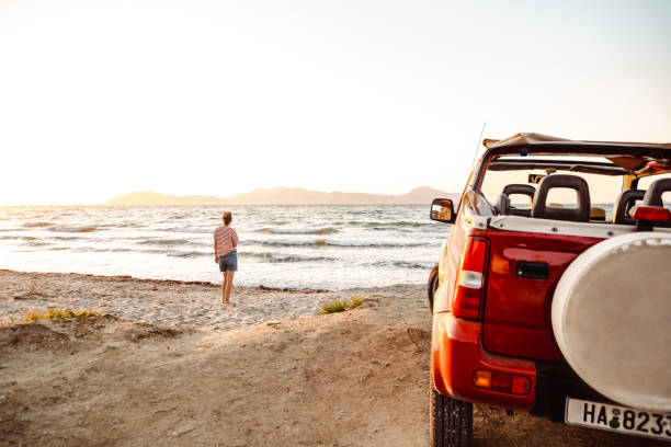 istock Young women enjoy the sunset on the beach 1412843047