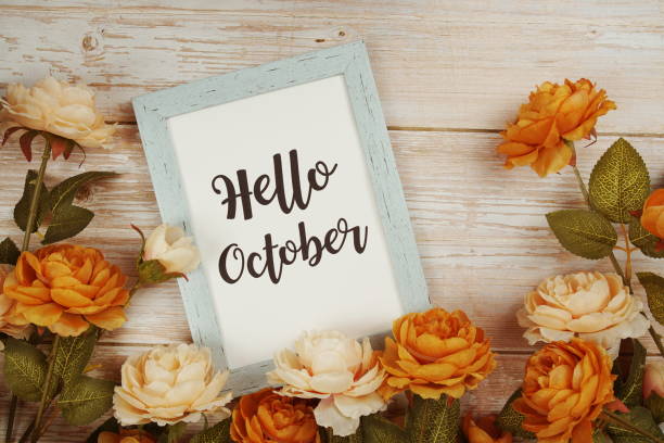 istock Hello October typography text with flower decoation on wooden background 1412843313