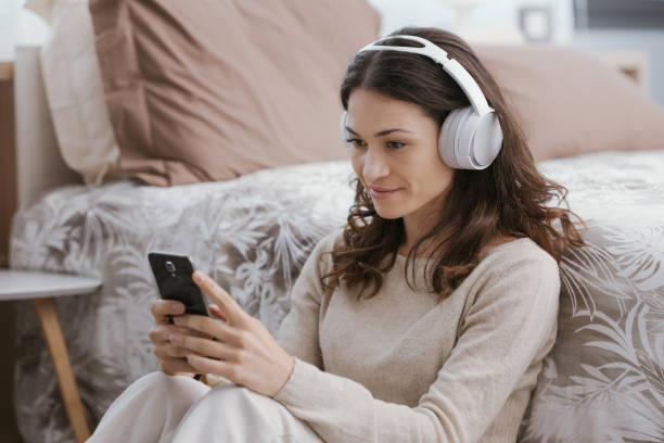 istock Woman watching videos on her phone 1412843471