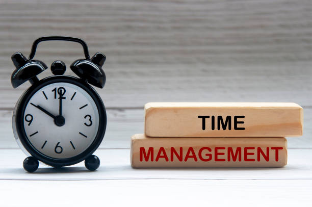 istock Alarm clock with text Time Management on wooden blocks. 1412844341