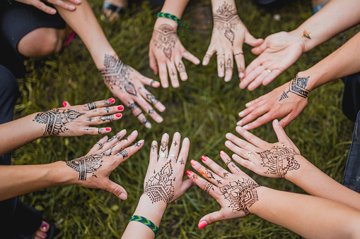 Henna tattoo painted arms of girls