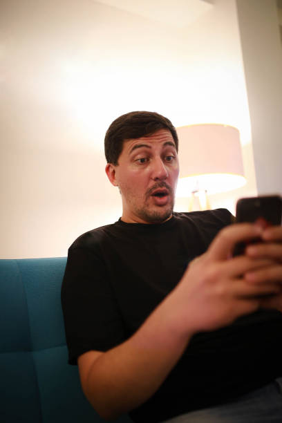 istock man watching video on his phone and having fun 1412846563