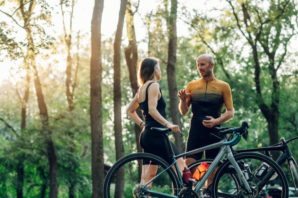 istock Happy couple riding road bicycles and taking a break during a sunset 1412846823