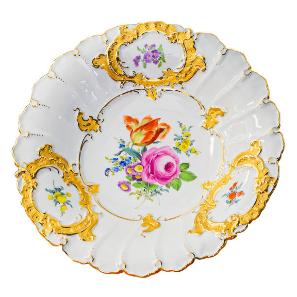 istock Vintage plate with flower pattern and golden decorations on white background. 1412848236