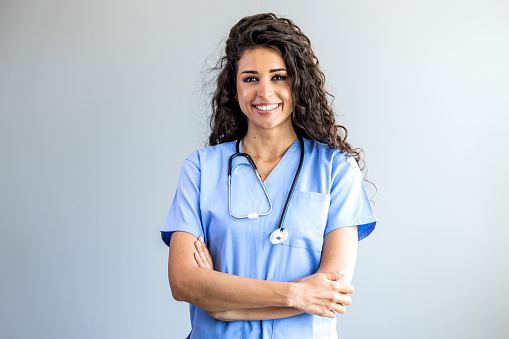 Portrait of a young nurse - doctor. Smiling Argentinian female nurse in medical scrubs. Shot of a female nurse standing confidently with her arms crossed. Portrait of female nurse at hospital