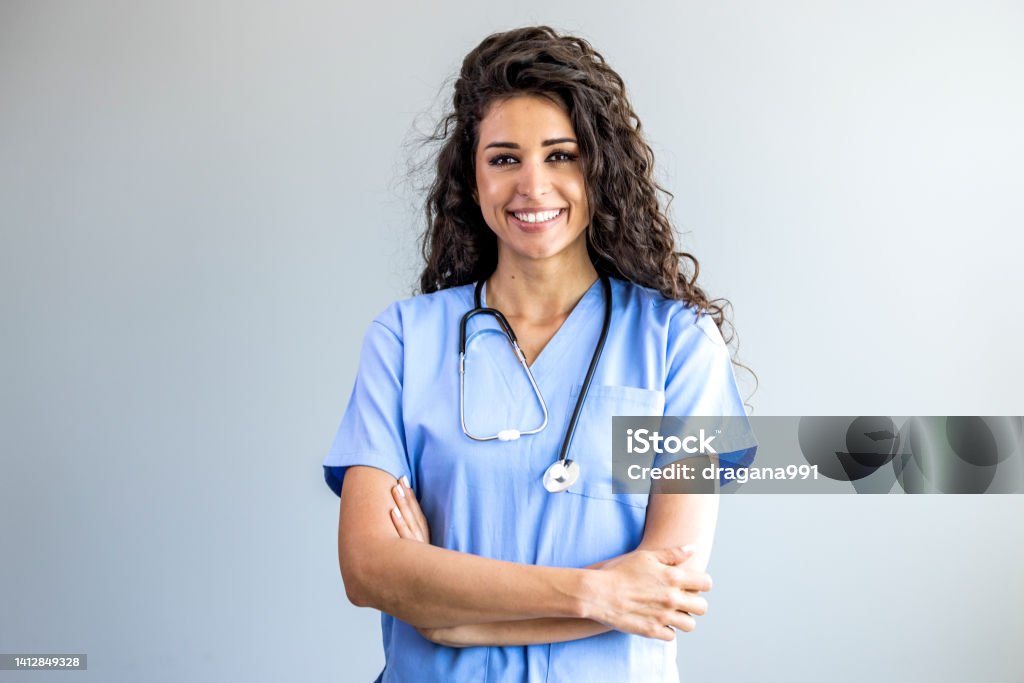 Portrait of a young nurse - doctor. Portrait of a young nurse - doctor. Smiling Argentinian female nurse in medical scrubs. Shot of a female nurse standing confidently with her arms crossed. Portrait of female nurse at hospital Female Nurse Stock Photo