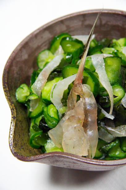 Kelp pickled Megochi, cucumber and seaweed vinegared dish. Kelp pickled Megochi, cucumber and seaweed vinegared dish.	Megochi, cucumber, and wakame seaweed. sunomono stock pictures, royalty-free photos & images