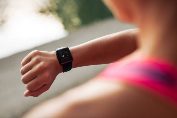 istock Sportswoman checking time on smartwatch 1412851094