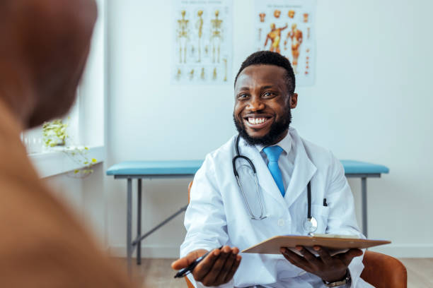 istock Doctor writing notes while examining a senior patient in a clinic 1412851949