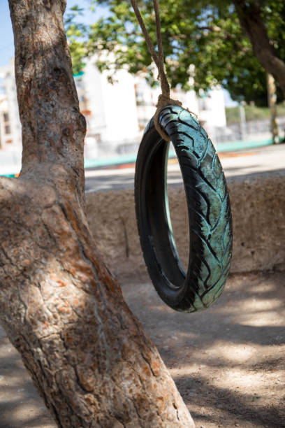 istock A car wheel painted and placed as a swing in a school. 1412852011